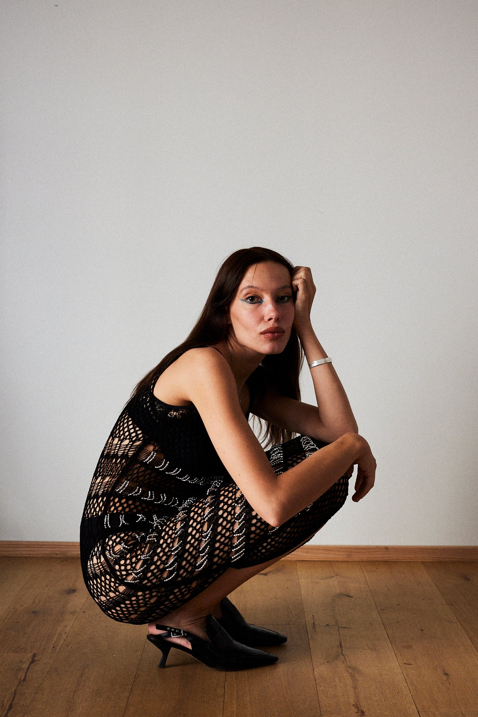 women sitting on the floor wearing a black dress with a sadria bracelet in silver